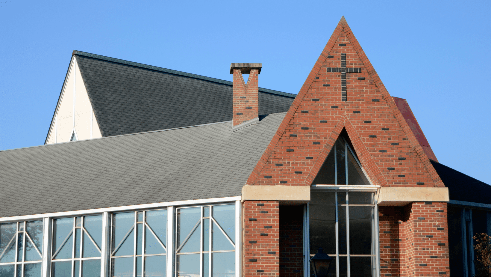 A church with a cross on the top of it.